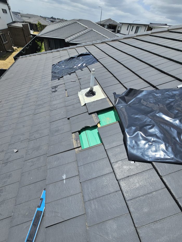 Roof tiles lifted exposing sarking underlay during inspection