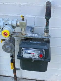 Gas meter and regulator inspection during gas leak detection service.