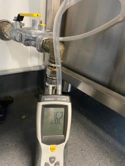 Gas pressure testing equipment connected to gas line in Sydney commercial property.