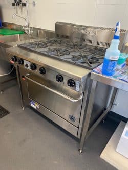 Commercial gas stove tested during gas pressure inspection in Sydney.
