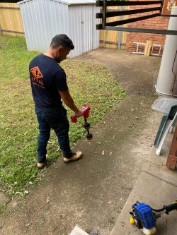 .Evolution Plumbing technician locating underground gas lines using specialised detection equipment.